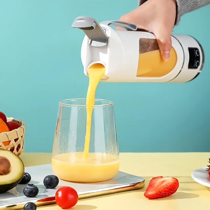 Hand pouring orange juice from a white and silver electric juicer into a glass on a table with fruits.