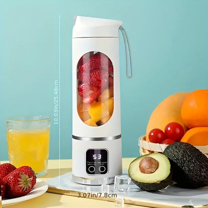 Portable blender with fruits and a glass of juice on a light blue background